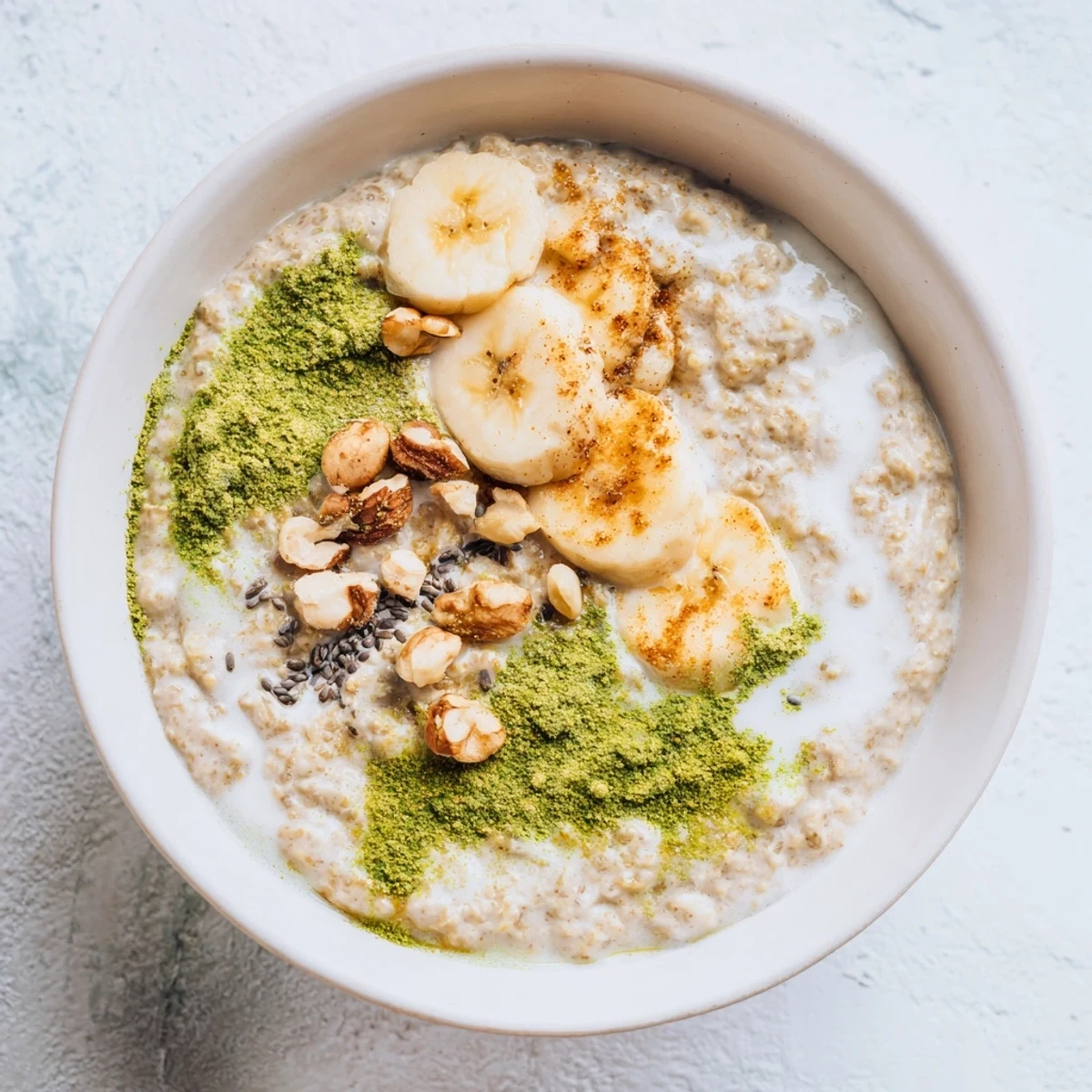 A close-up of High-Protein Eggnog Matcha Overnight Oats, showcasing a festive, layered breakfast with a spoon.
