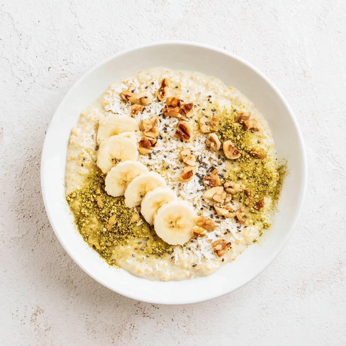Vibrant image shows chilled High-Protein Eggnog Matcha Overnight Oats, garnished with spices and nuts for a flavorful meal.