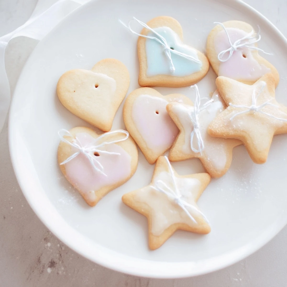 Delicious Mignonneries Coeurs et Étoiles Rubans, star and heart cookies, tied with elegant ribbons, ready to enjoy.