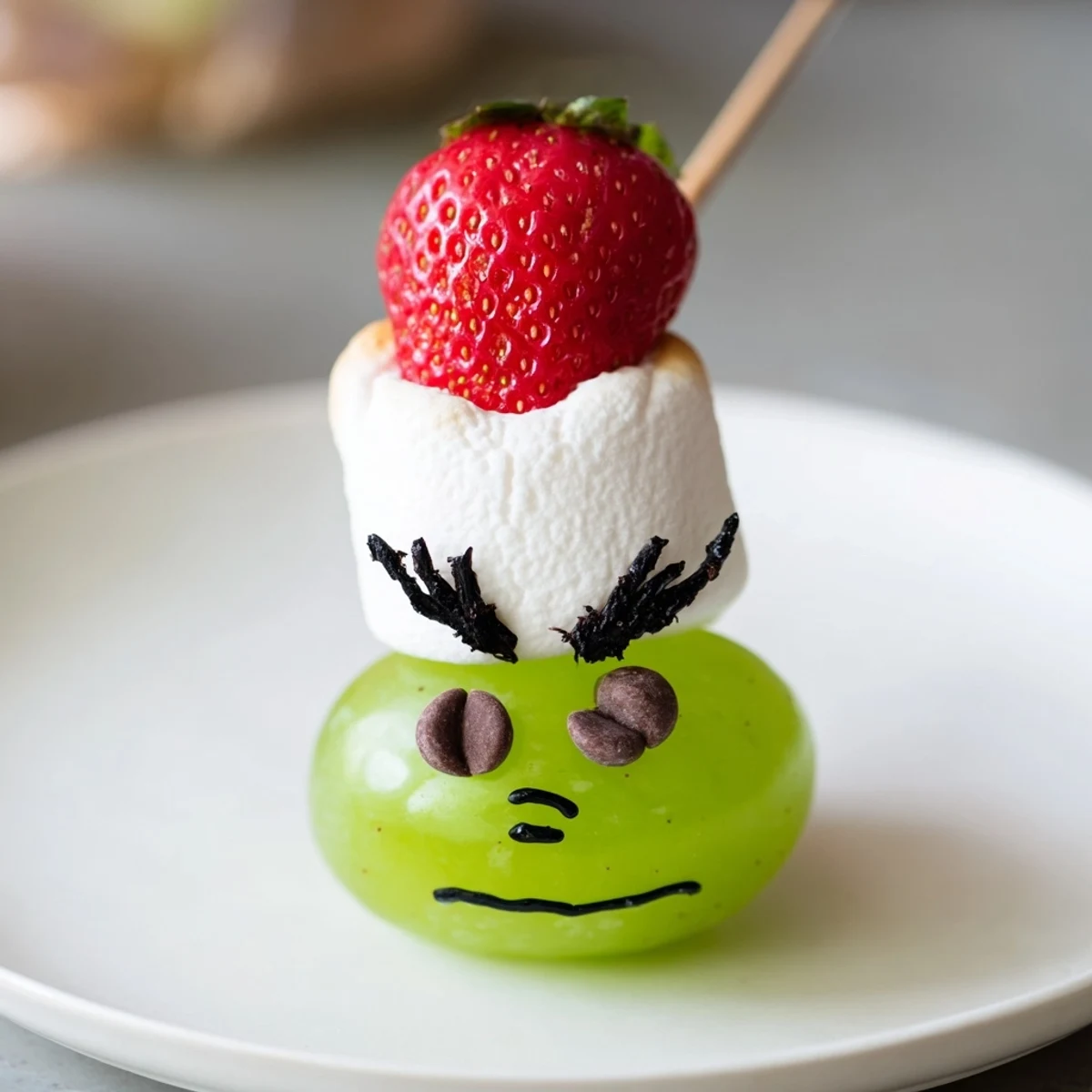 Festive Grinch Snack: a fun, quick treat made with juicy grapes and fluffy marshmallows.