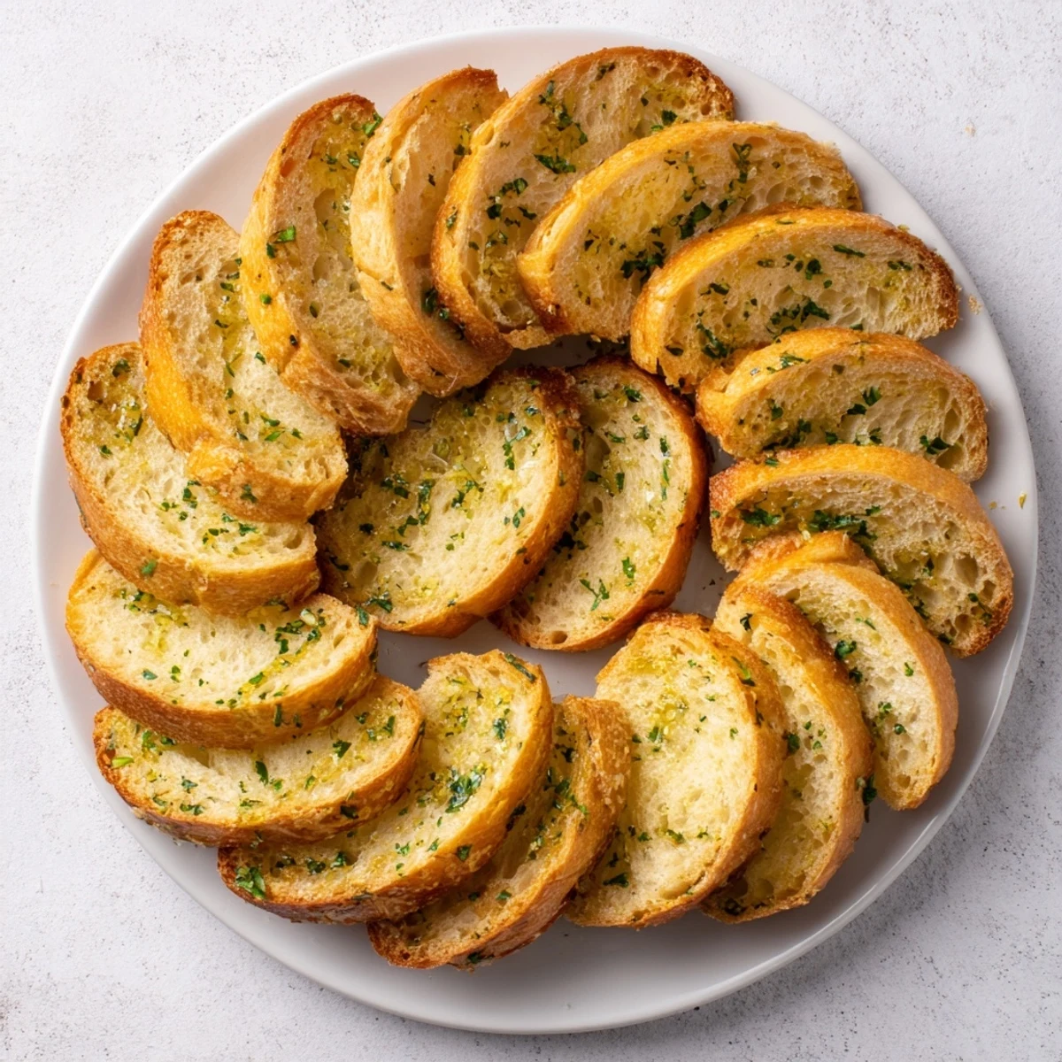 Golden, crusty baguette slices arranged in a circle, ready to pair with your favorite dips.