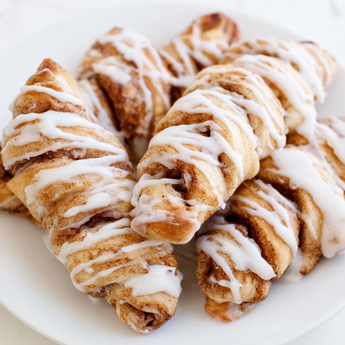 Golden, air-fryer cinnamon roll twists, warm and glazed, perfect as a quick, sweet breakfast.