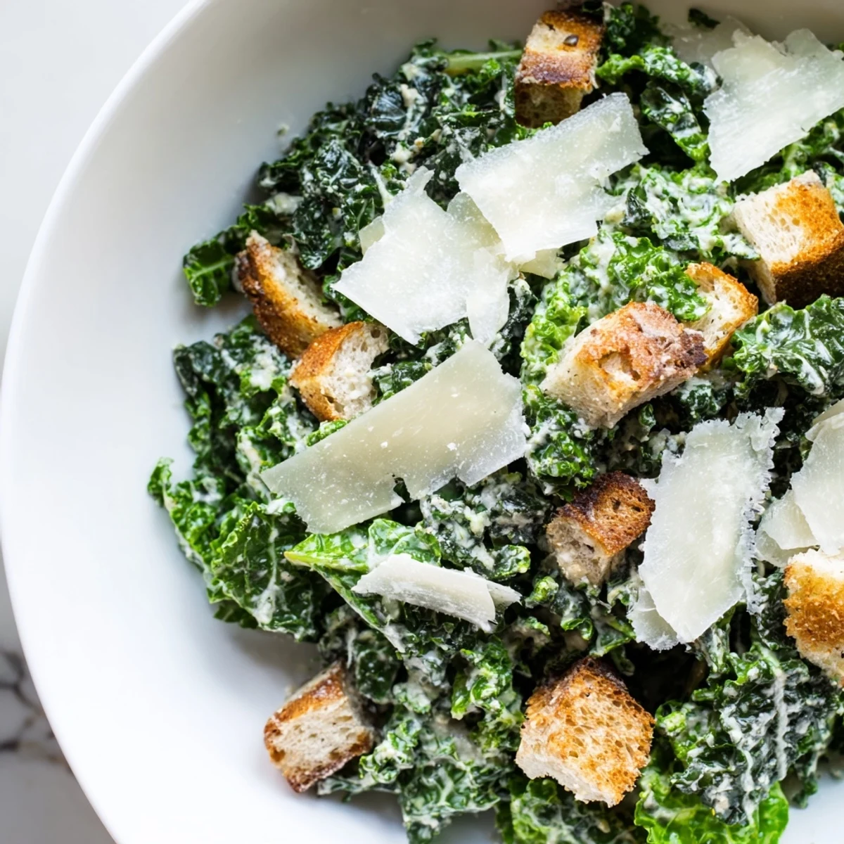 Creamy homemade dressing coats the tender kale in this delicious, vegetarian Kale Caesar Salad.
