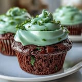 Rich and moist green velvet cupcakes, perfectly baked and topped with creamy frosting for a festive dessert.