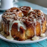Cinnamon Roll Pancake Casserole with Cream Cheese Glaze: A golden baked casserole with cinnamon sugar swirls, fluffy pancake layers, and a rich cream cheese drizzle.