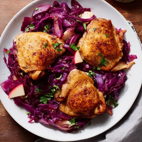 Golden-brown Oktoberfest Chicken and Red Cabbage Bake, with tender chicken and glistening, sweet cabbage.