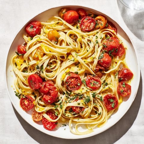 Cozy Fireplace One-Pan Tomato Basil Pasta with blistered tomatoes and fresh basil, ready to serve.