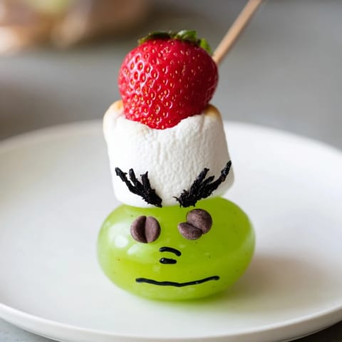 Festive Grinch Snack: a fun, quick treat made with juicy grapes and fluffy marshmallows.