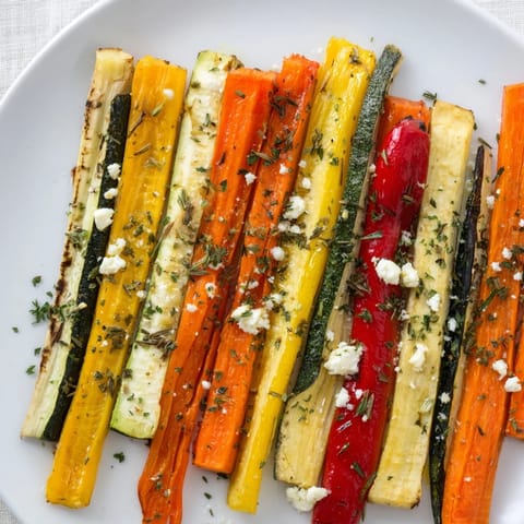 Brightly colored Christmas Sleigh Veggie Rails arranged on a platter, ready to be served and enjoyed at a party.