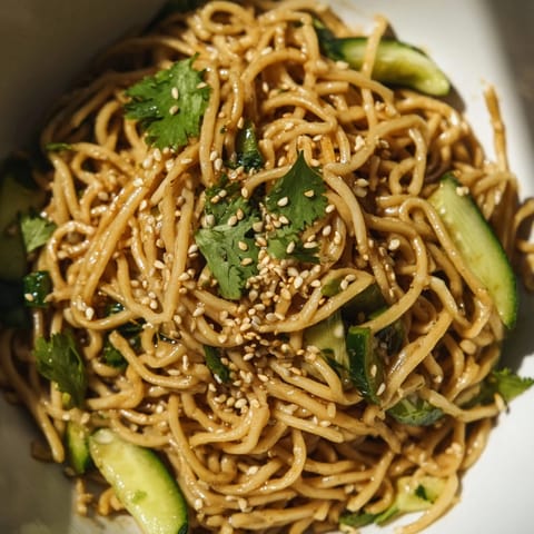 This vibrant Spicy Sesame Noodle Salad features julienned cucumbers and toasted sesame seeds, perfect for a quick, light lunch.