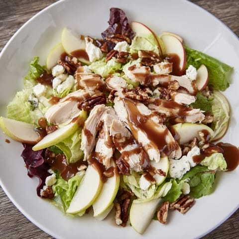 Vibrant Caramel Apple Chicken Salad with tender sliced chicken, crisp apple wedges, mixed greens, and crumbled feta, drizzled with caramel-pecan dressing.