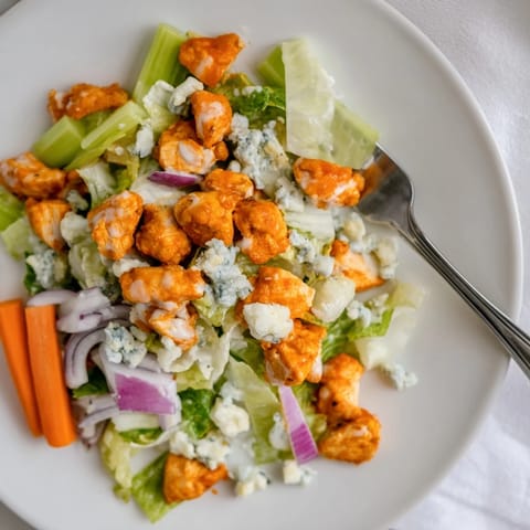 Fresh romaine, diced celery, and buffalo chicken create a zesty, gluten-free main dish salad for lunch.  