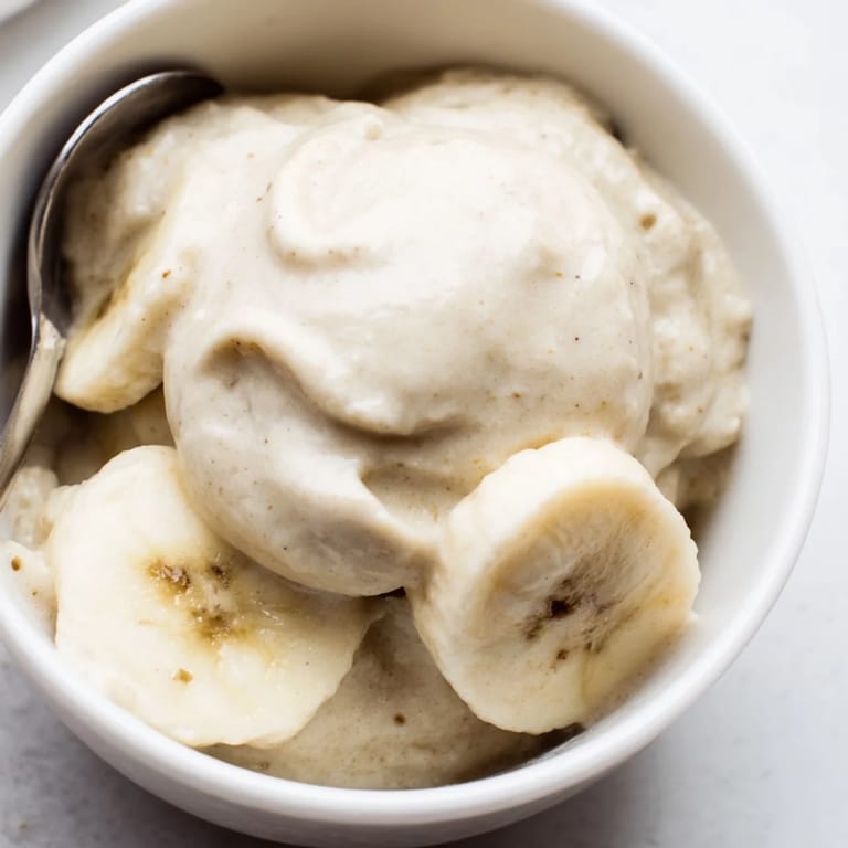 Bright white 2-Ingredient Banana Ice Cream, ready to scoop, a refreshing, low-fat dessert.