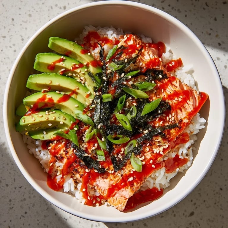 This flavorful Classic Salmon Rice features a vibrant mix of toppings like sesame seeds and spring onions, ready to eat.