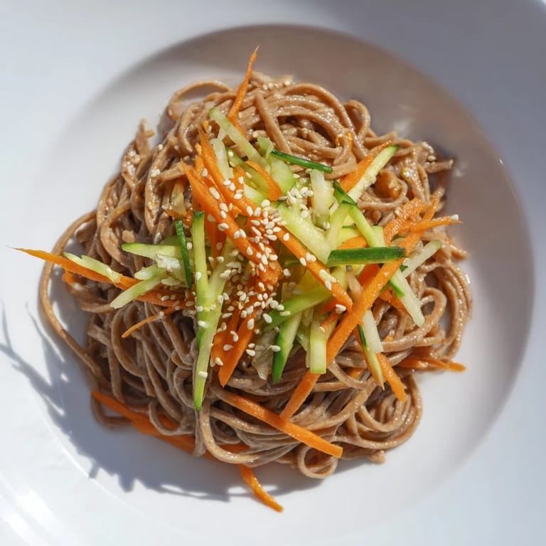 A close-up shot of delicious Chilled Noodle Lunch Cups, showcasing fresh cucumbers and carrots.