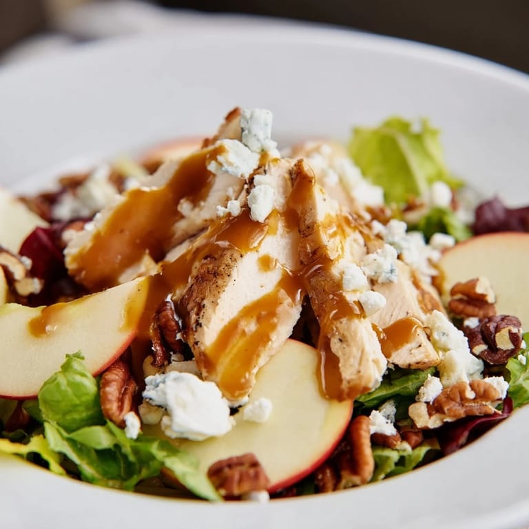 Hearty Caramel Apple Chicken Salad tossed with juicy apples, savory chicken, and toasted pecans, served on a rustic platter for fall.