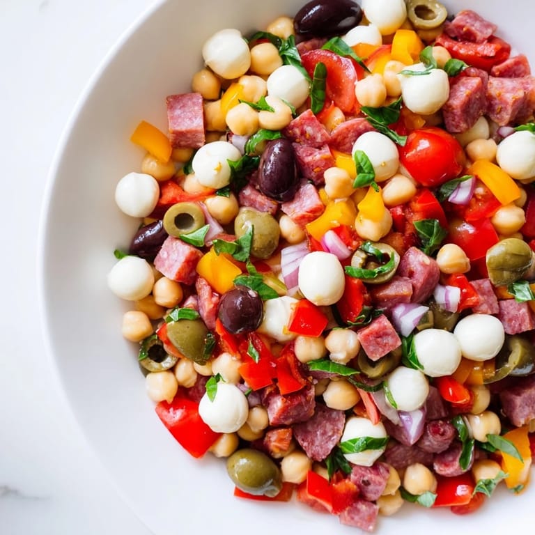 Fresh chopped vegetables and tangy pepperoncini in a bowl of Crunchy Antipasto Chopped Salad.