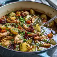 Slow Cooker Chicken Pot Pie Soup with tender chicken and creamy vegetables in a hearty broth, perfect for a comforting dinner.